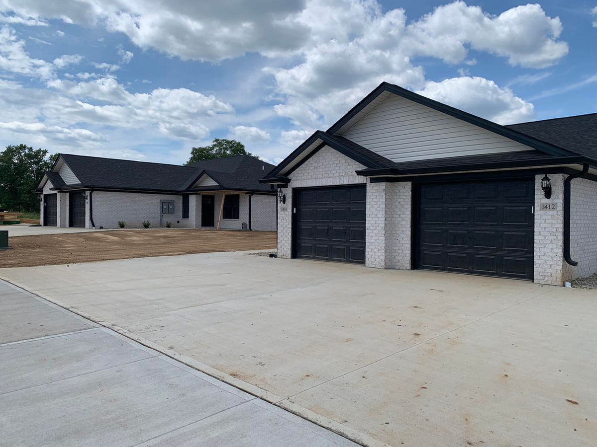 New-construction townhomes with garage doors installed by EZ Open for a contractor